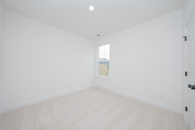 carpeted spare room with baseboards