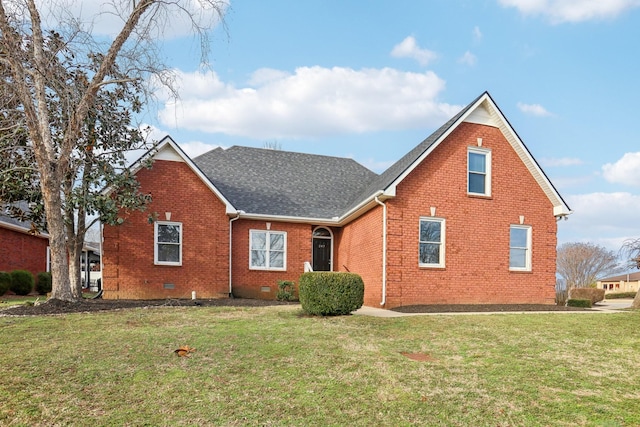 rear view of house featuring crawl space, brick siding, a yard, and roof with shingles