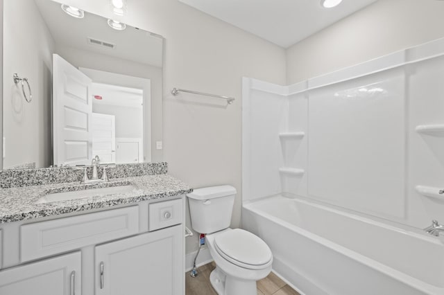 bathroom featuring baseboards, visible vents, toilet, vanity, and shower / washtub combination