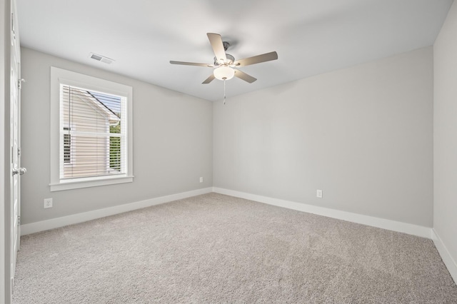 spare room with a ceiling fan, baseboards, visible vents, and carpet flooring