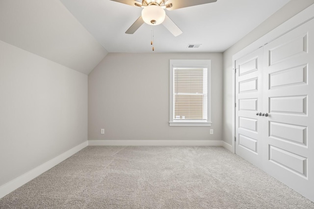 additional living space featuring carpet, visible vents, vaulted ceiling, ceiling fan, and baseboards