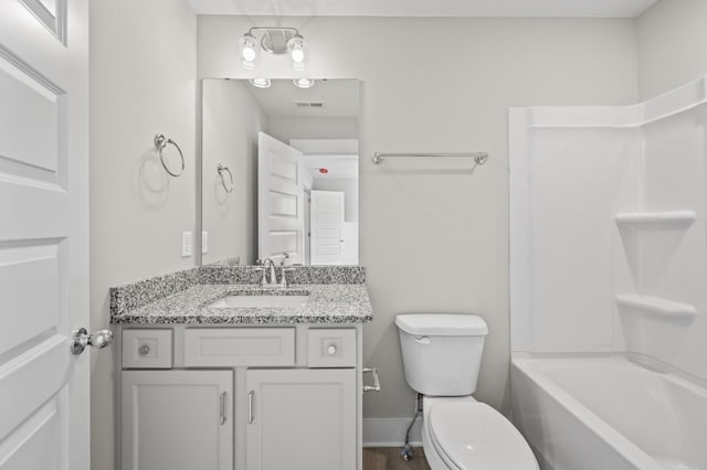 bathroom with visible vents, toilet, vanity, shower / tub combination, and baseboards