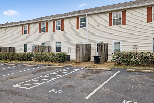 exterior space with uncovered parking and fence