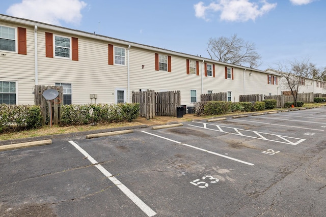 exterior space featuring uncovered parking and fence