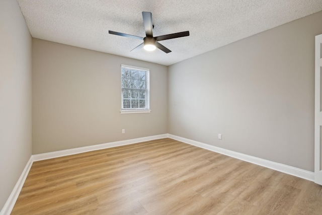 unfurnished room featuring light wood-style flooring, a textured ceiling, baseboards, and a ceiling fan