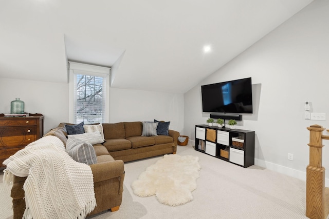 carpeted living room featuring baseboards and vaulted ceiling