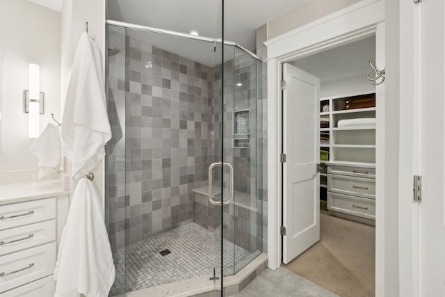 full bath featuring a stall shower and a spacious closet