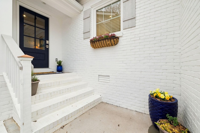 property entrance with brick siding