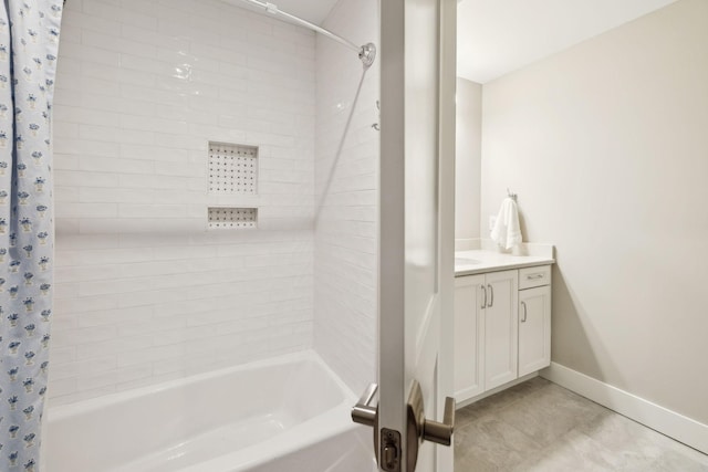 full bath with tile patterned flooring, shower / tub combo with curtain, vanity, and baseboards