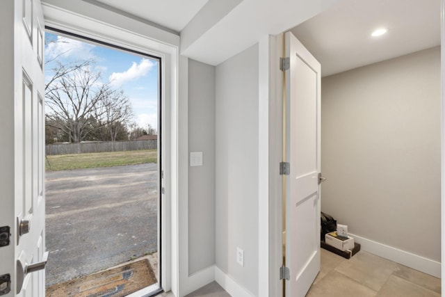 doorway to outside with baseboards