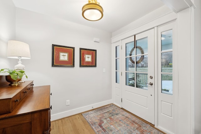 entrance foyer with wood finished floors and baseboards