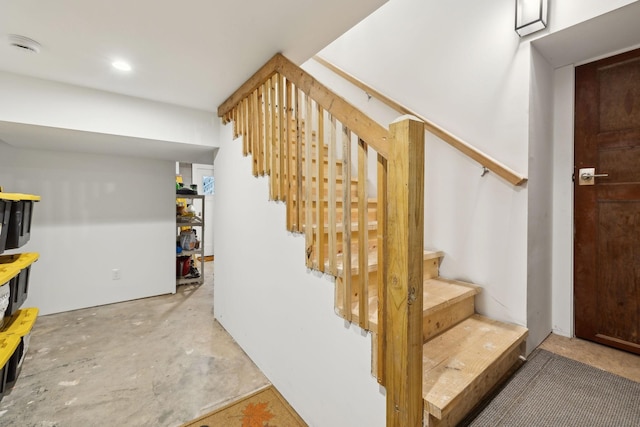 stairway featuring concrete floors