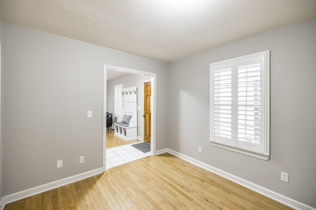 spare room featuring hardwood / wood-style floors and baseboards