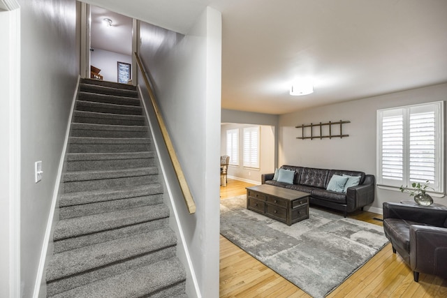 stairs with wood-type flooring and baseboards