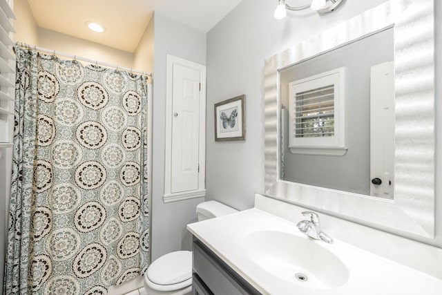 bathroom featuring toilet, curtained shower, and vanity