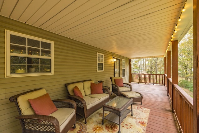 deck featuring covered porch and outdoor lounge area