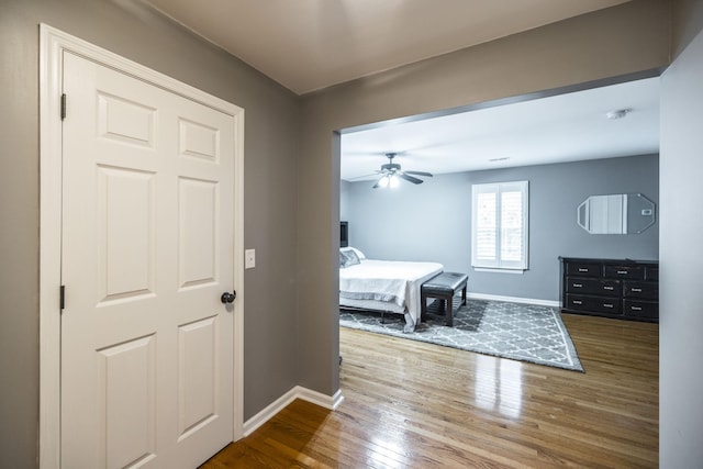 bedroom with wood finished floors and baseboards