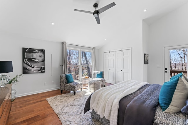 bedroom with wood finished floors, a ceiling fan, baseboards, vaulted ceiling, and a closet