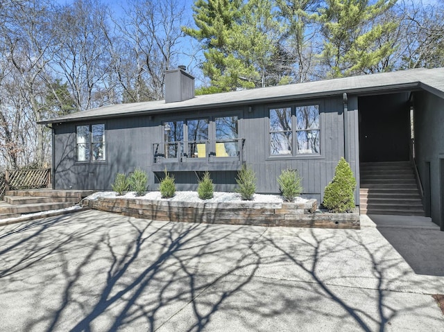 back of house featuring a patio area and a chimney