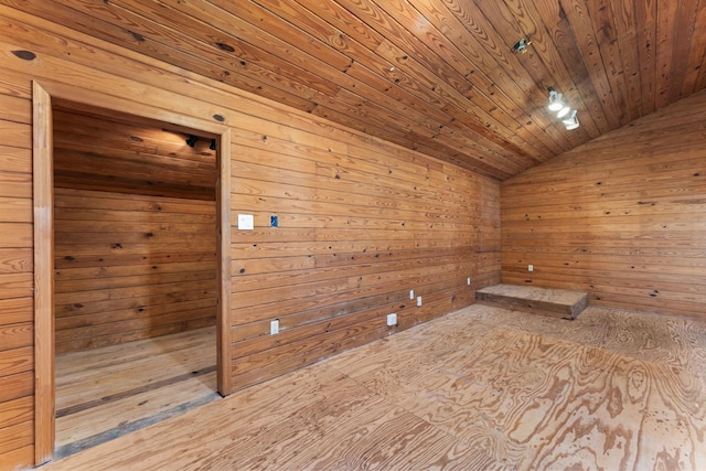 unfurnished room with vaulted ceiling, a sauna, wood walls, and wooden ceiling