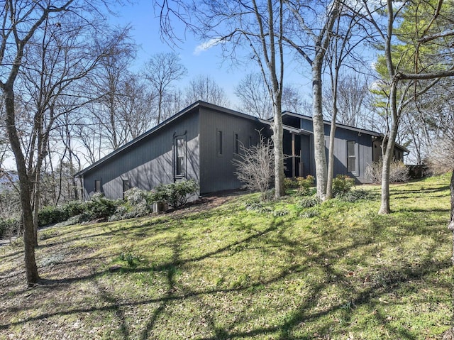 view of side of home featuring a yard