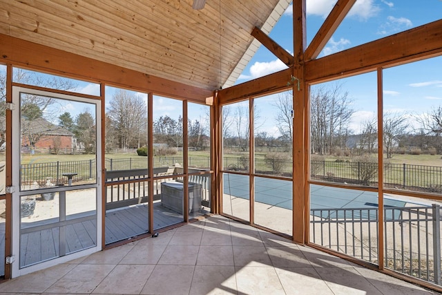 unfurnished sunroom featuring lofted ceiling