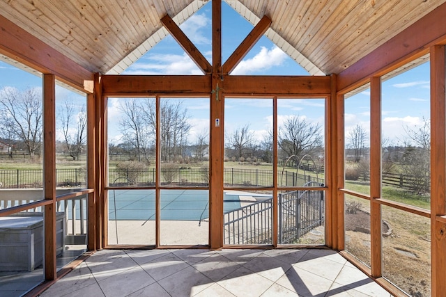 unfurnished sunroom with a healthy amount of sunlight, wooden ceiling, and vaulted ceiling