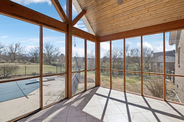 unfurnished sunroom with lofted ceiling and wood ceiling