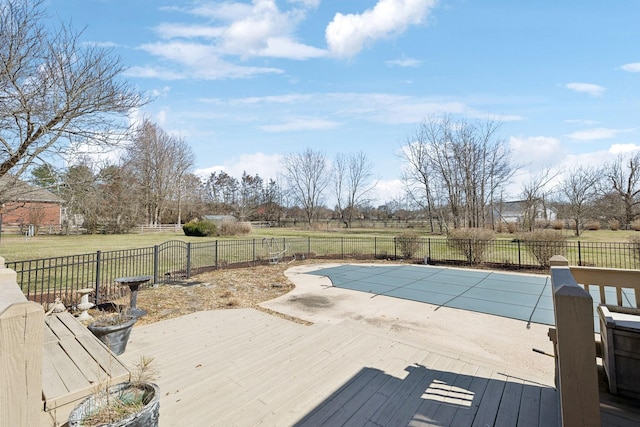 view of pool featuring a wooden deck, a lawn, a fenced backyard, and a fenced in pool