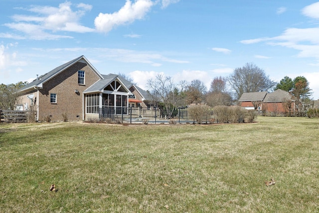 view of yard featuring a sunroom and fence