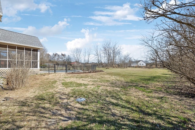 view of yard with fence and a sunroom