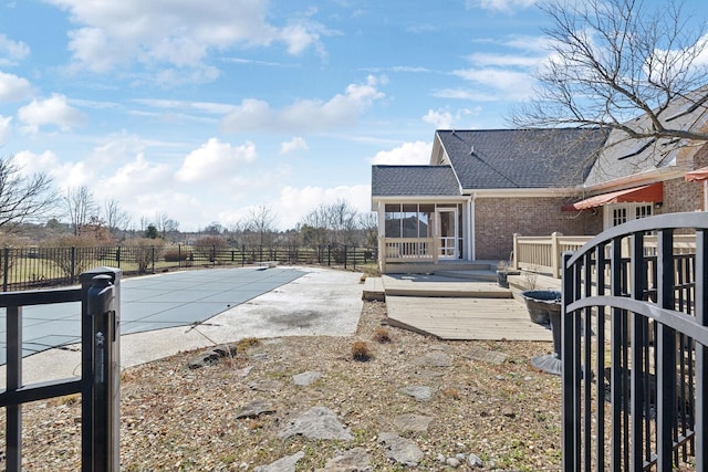 view of pool featuring a deck, a patio area, fence, and a fenced in pool