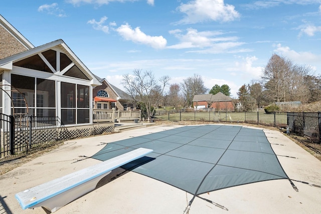 view of pool featuring a fenced in pool, a sunroom, a patio area, fence, and a wooden deck