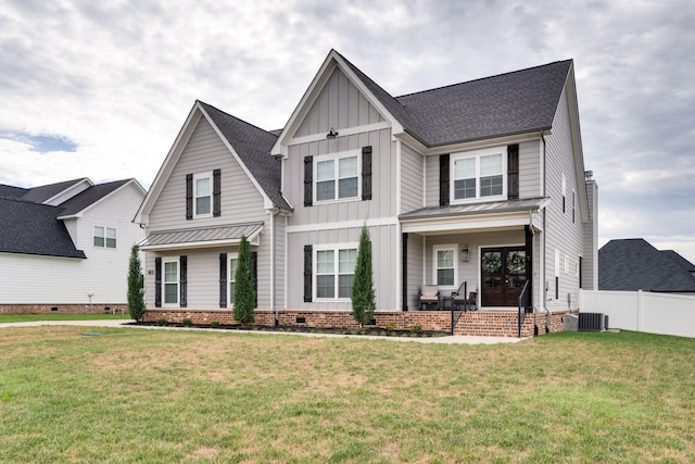 modern farmhouse style home with board and batten siding, crawl space, fence, and a front lawn