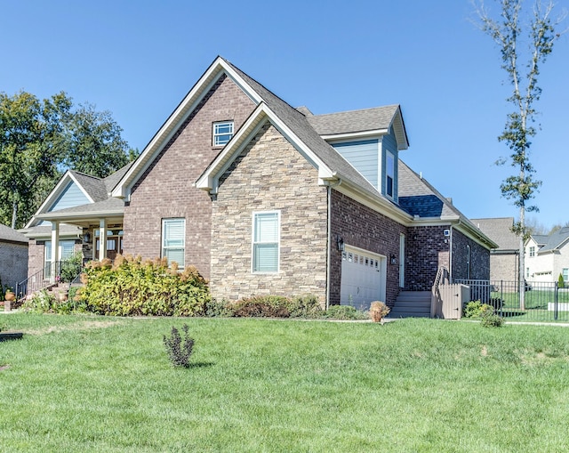 craftsman house with a front yard, brick siding, and fence