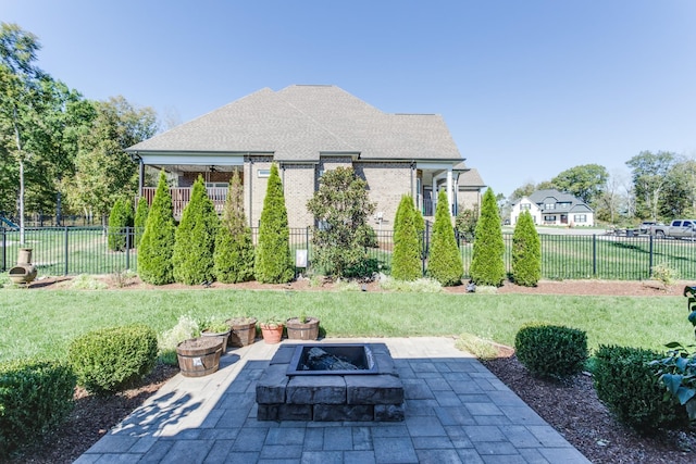 view of yard featuring an outdoor fire pit, fence, and a patio