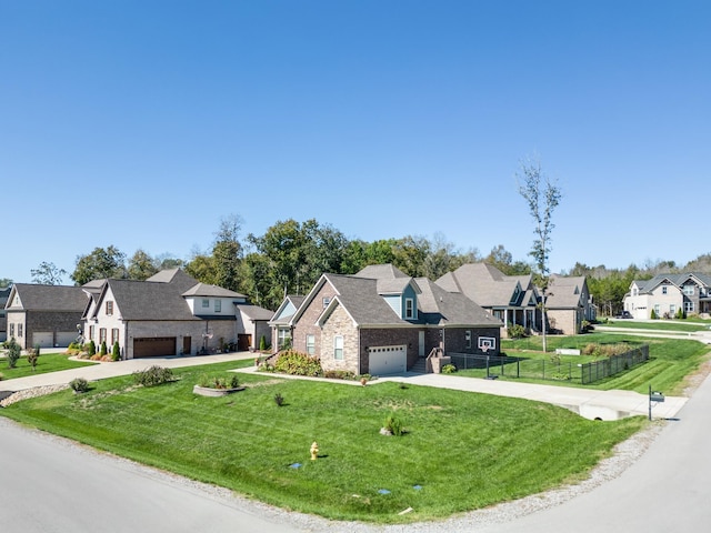 view of front of house with concrete driveway, a front lawn, fence, and a residential view