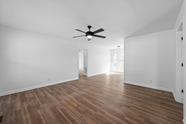 spare room featuring ceiling fan, wood finished floors, visible vents, and baseboards