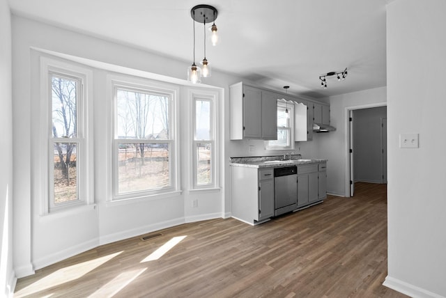 kitchen featuring baseboards, wood finished floors, dishwasher, and gray cabinetry