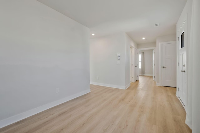 spare room with light wood-type flooring, visible vents, baseboards, and recessed lighting