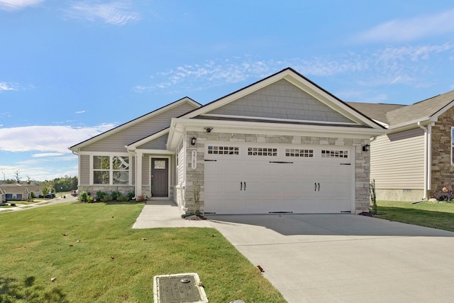 craftsman house featuring a garage, a front yard, stone siding, and concrete driveway