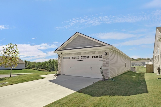 view of home's exterior with stone siding, a lawn, and a detached garage