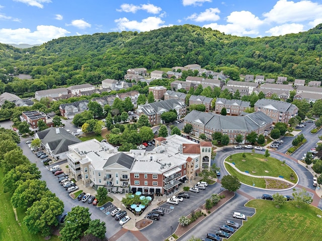 drone / aerial view with a wooded view