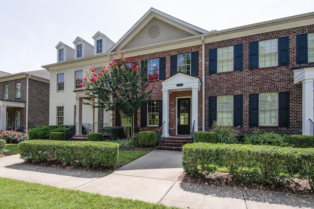 view of front of house featuring brick siding