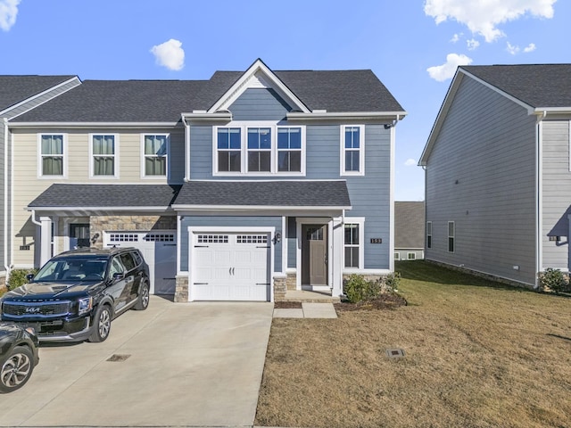 view of front of property featuring a garage, stone siding, driveway, roof with shingles, and a front lawn