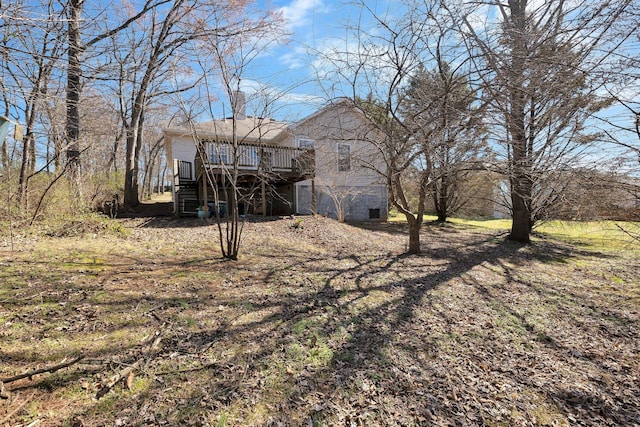 view of yard with a wooden deck and stairs