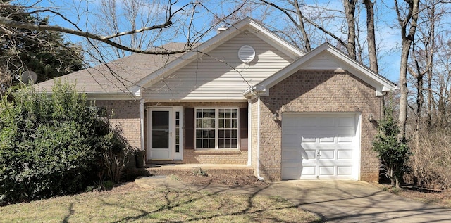 ranch-style house featuring a garage, concrete driveway, and brick siding