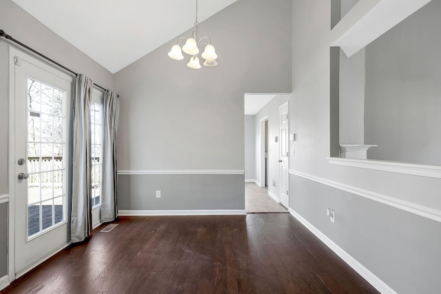 interior space featuring a notable chandelier, baseboards, and wood finished floors