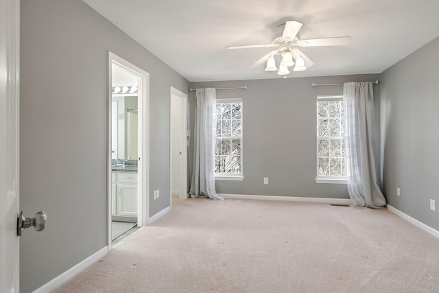 empty room featuring carpet floors, visible vents, baseboards, and a ceiling fan