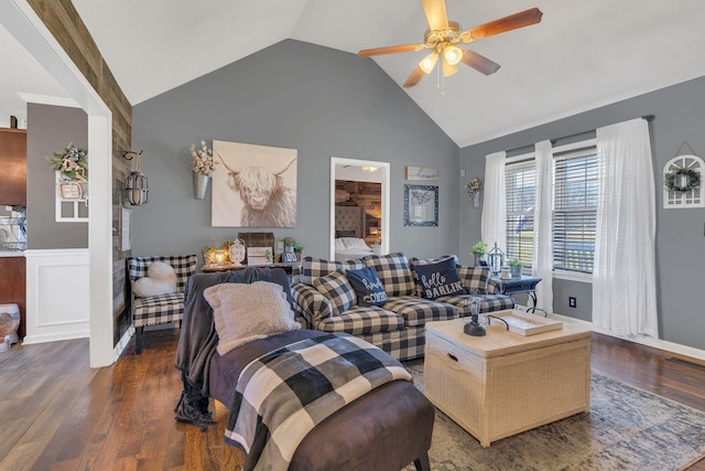 living area featuring high vaulted ceiling, wainscoting, ceiling fan, and wood finished floors